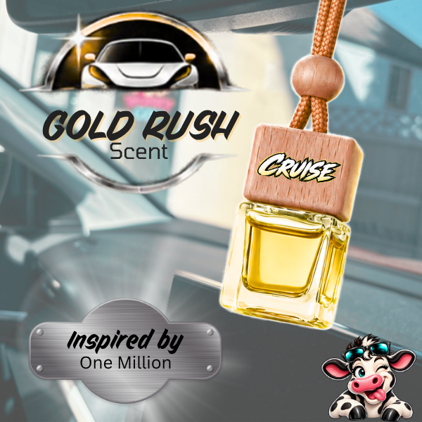 A car air freshener bottle labeled 'CRUISE' with a wooden cap, hanging from a cord in front of a blurred car interior. The image includes 'GOLD RUSH Scent' branding, an 'Inspired by One Million' badge, and a cartoon cow graphic.