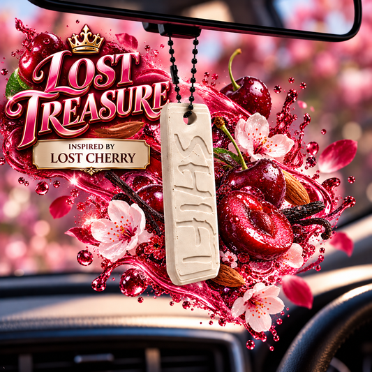 A car air freshener pendant labeled 'SHI'S' hangs from a black bead string in front of a rearview mirror. The pendant is cream-colored with the name carved into it, surrounded by a vibrant graphic of cherries, pink blossoms, and red syrup splashes.