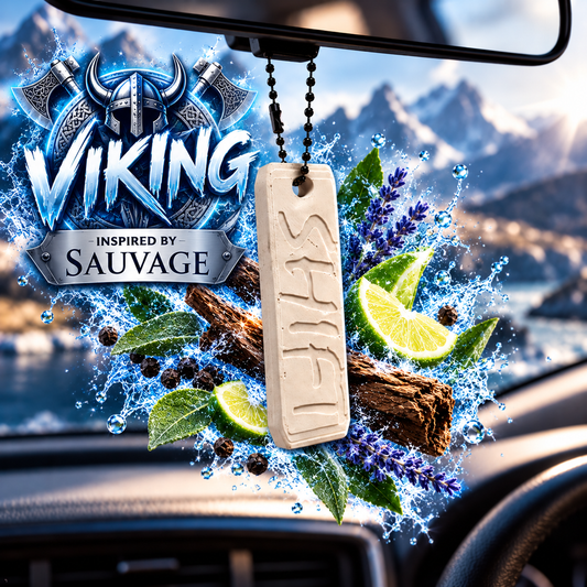 A hanging car air freshener charm with a carved rune-like symbol, shown in front of a windshield with a dramatic mountain landscape graphic and the text 'VIKING INSPIRED BY SAUVAGE' behind it.
