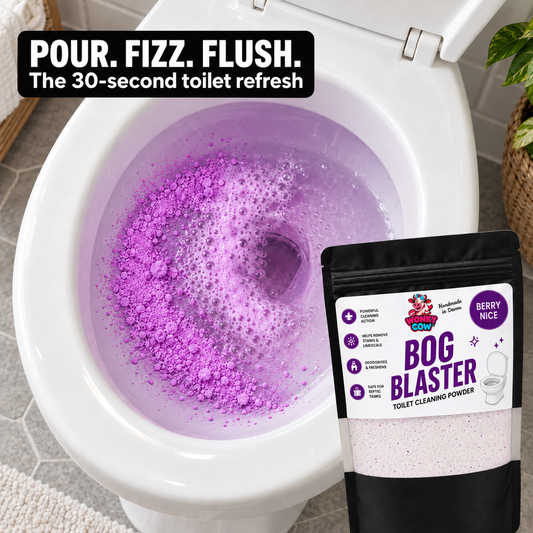 A package of Berry Nice Bog Blaster Toilet Cleaning Powders shown next to a white toilet bowl filled with purple fizzing powder and foam. A black text banner at the top reads 'POUR.